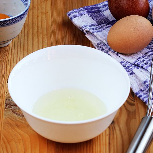 fresh-eggs-being-separated-into-white-bowl-with-whisk